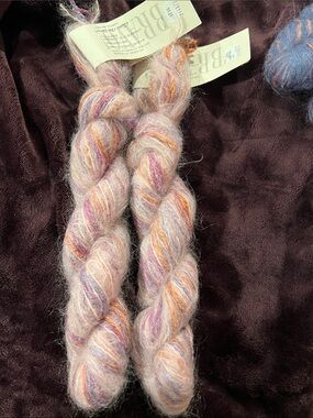 2 yarn hanks 40% rayon 35% mohair 13% silk 6% wool 6% nylon pink purple orange